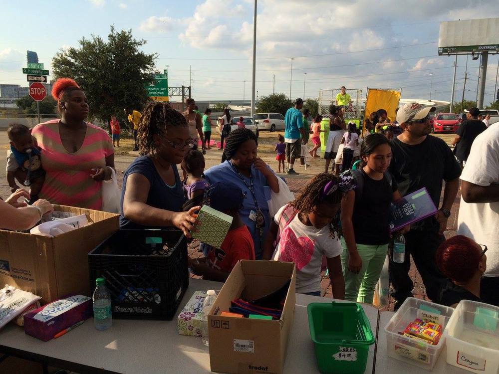 Families wait in line to cash in their points for new school supplies.