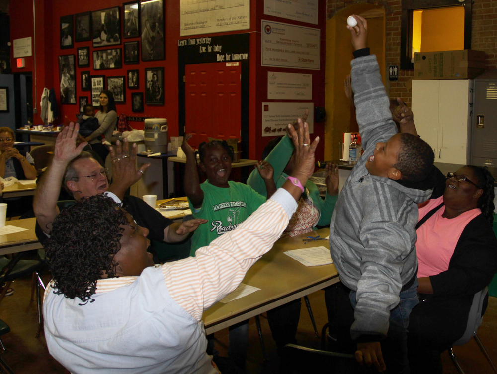 Gabriel, his family, and his mentor Bo celebrate their egg drop victory.
